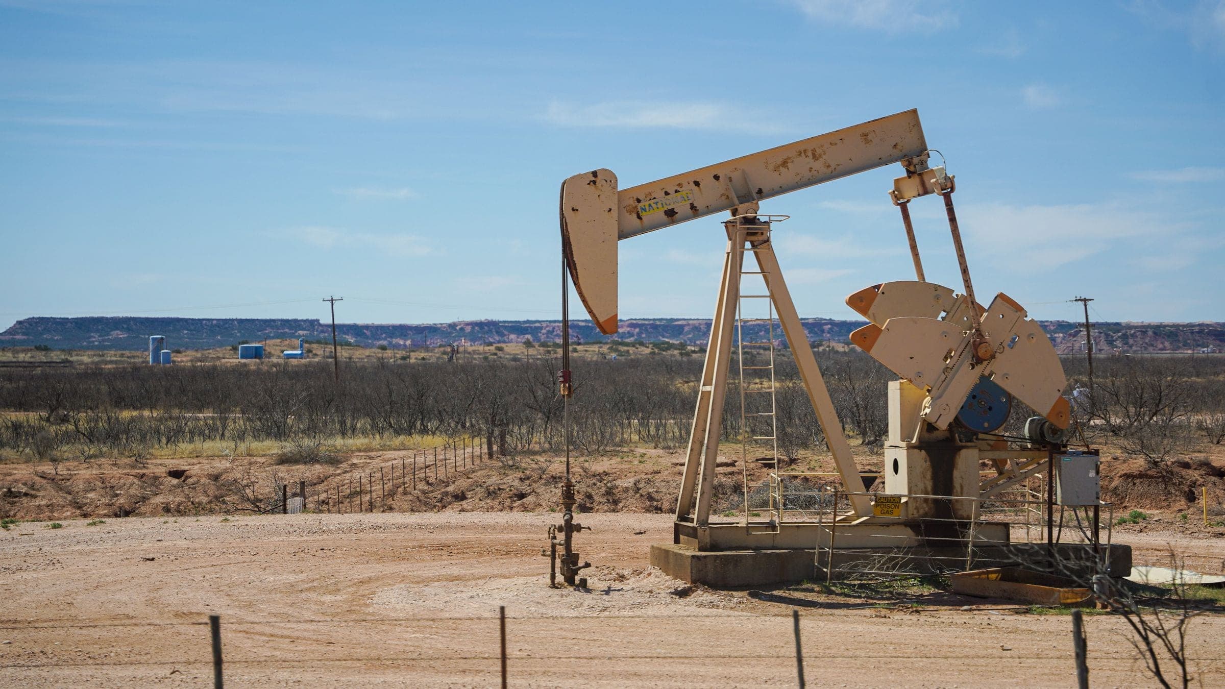 An oil pumpjack on a caliche pad in the mesquite flats around Andrews, TX